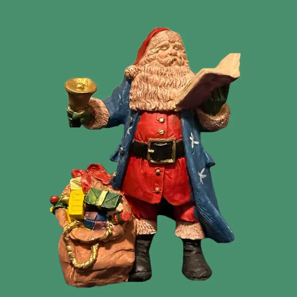Gorgeous blue robed Santa rings a bell and reads to the crowds!